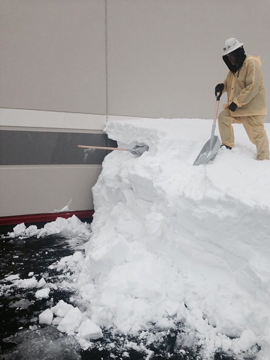 worker removing snow