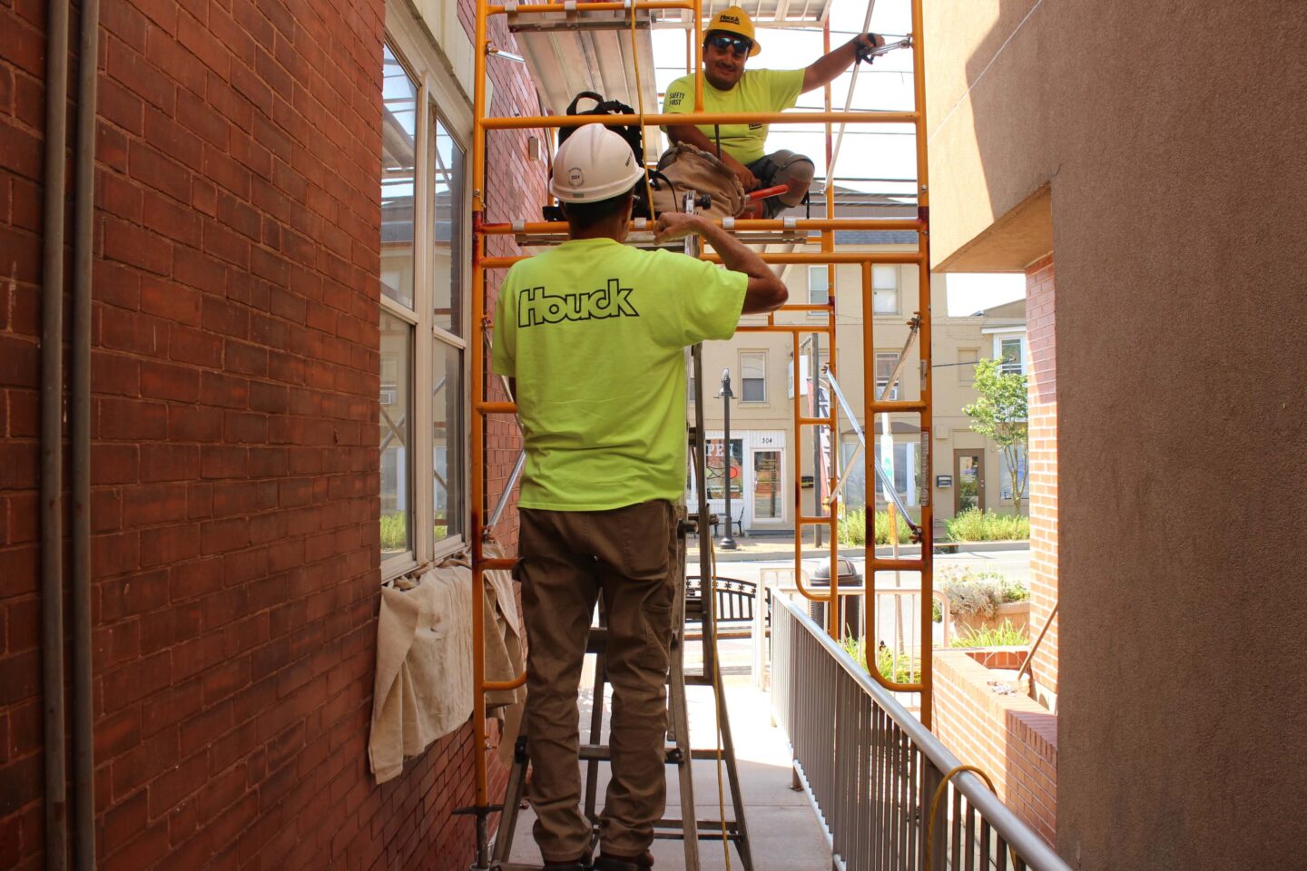 Masonry specialist restoring brick building exterior.