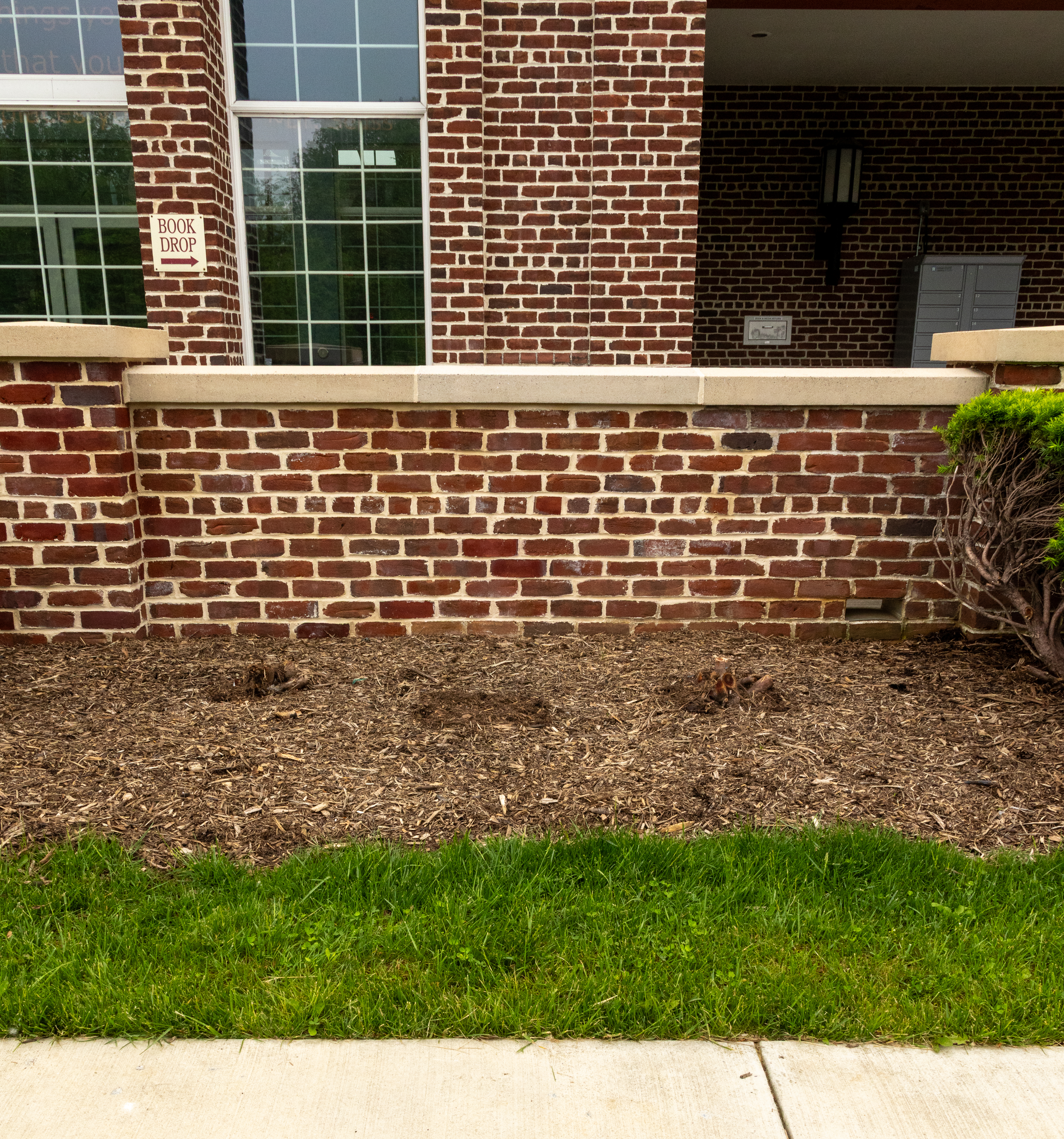 Full view of restored brick wall in front of a public library.