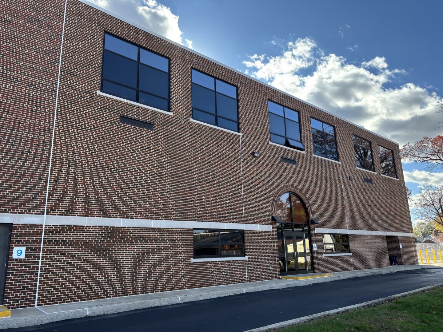 Side view of repaired brick facade on elementary school building exterior.