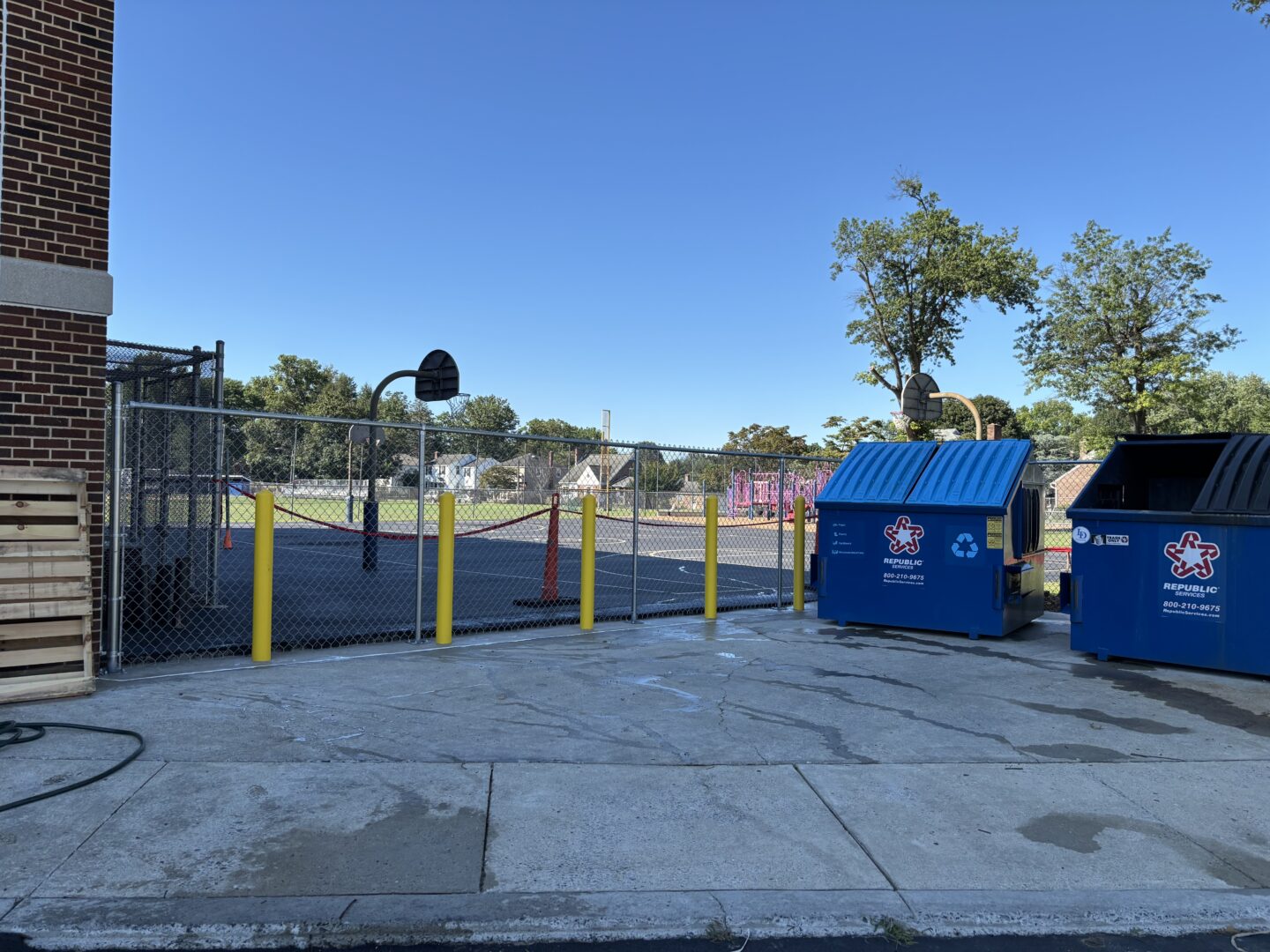 View of new chain-link fence around dumpster area.