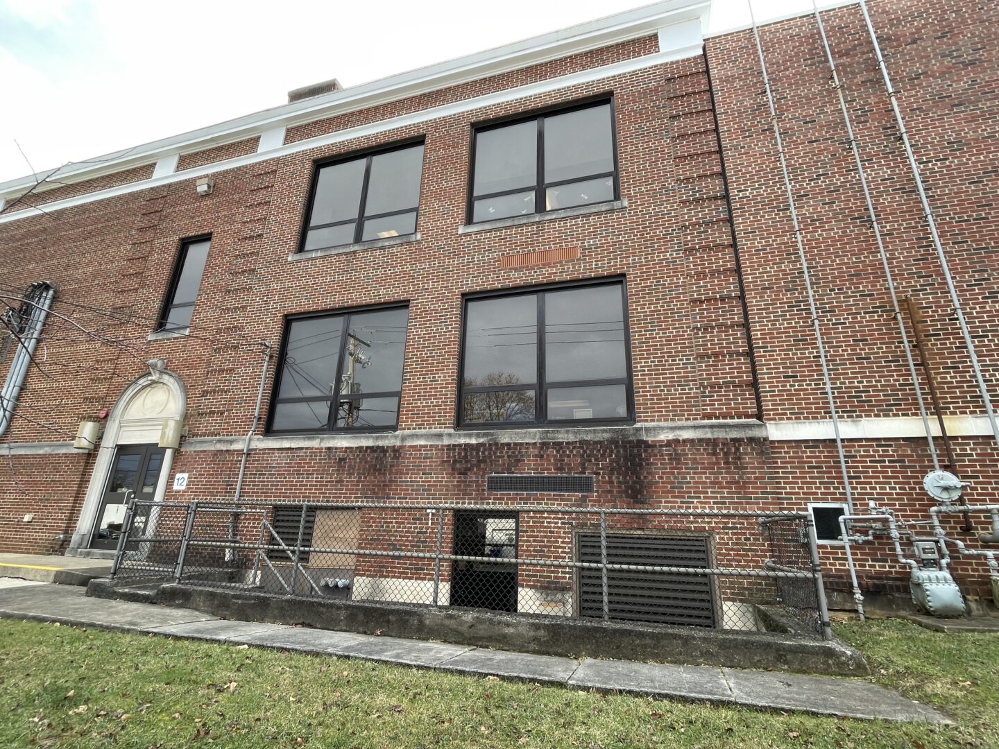 Exterior view of damaged brick facade around windows.