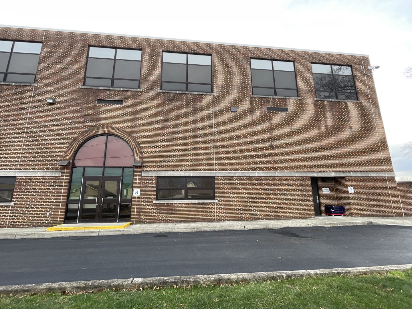 Exterior view of elementary school with worn down brick facade.