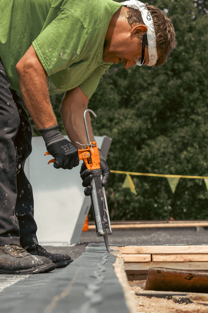 Close up of Houck team repairing roof.